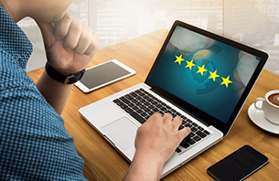 Businessman looking at 5 star rated services website